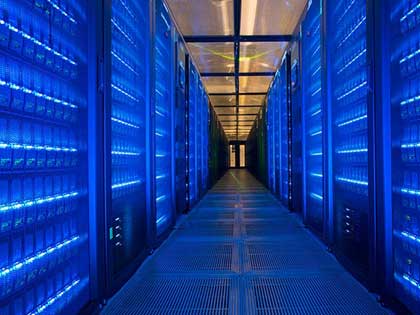 UCL data server centre with server racks looking along long corridor lit up in blue. Water treatment services were conducted here