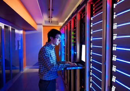 man using computer at a server centre where Euroflo specialise in the pre-commissioning cleaning of closed water systems and other services